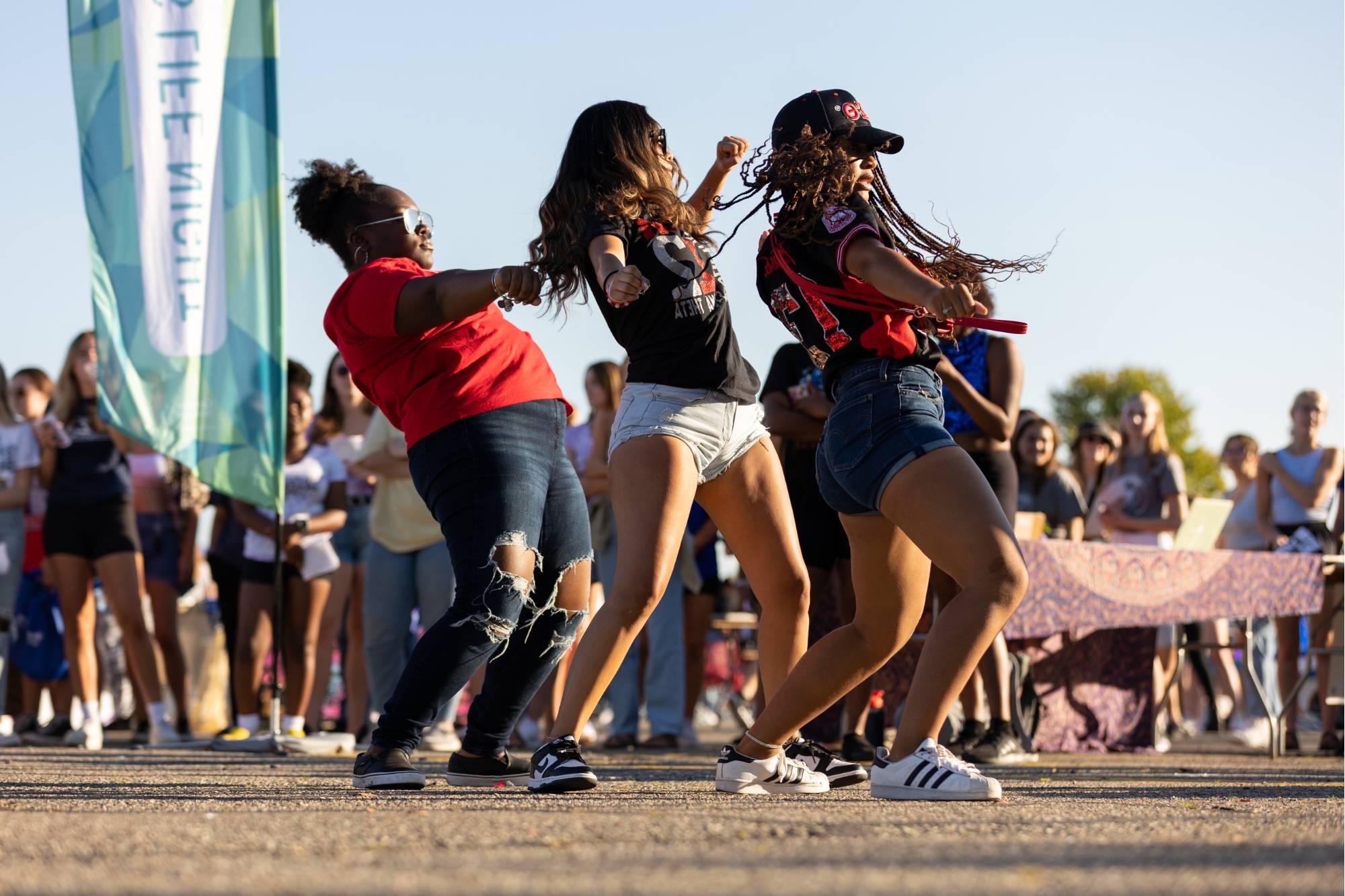 Three students dancing at Campus Life Night